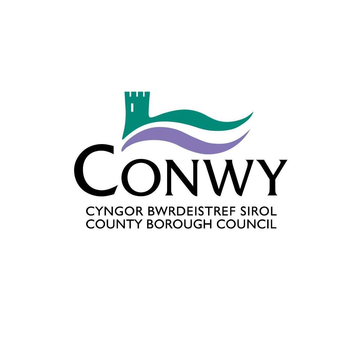 Conwy County Borough Council logo featuring a stylized green castle and waves above the text in Welsh and English.