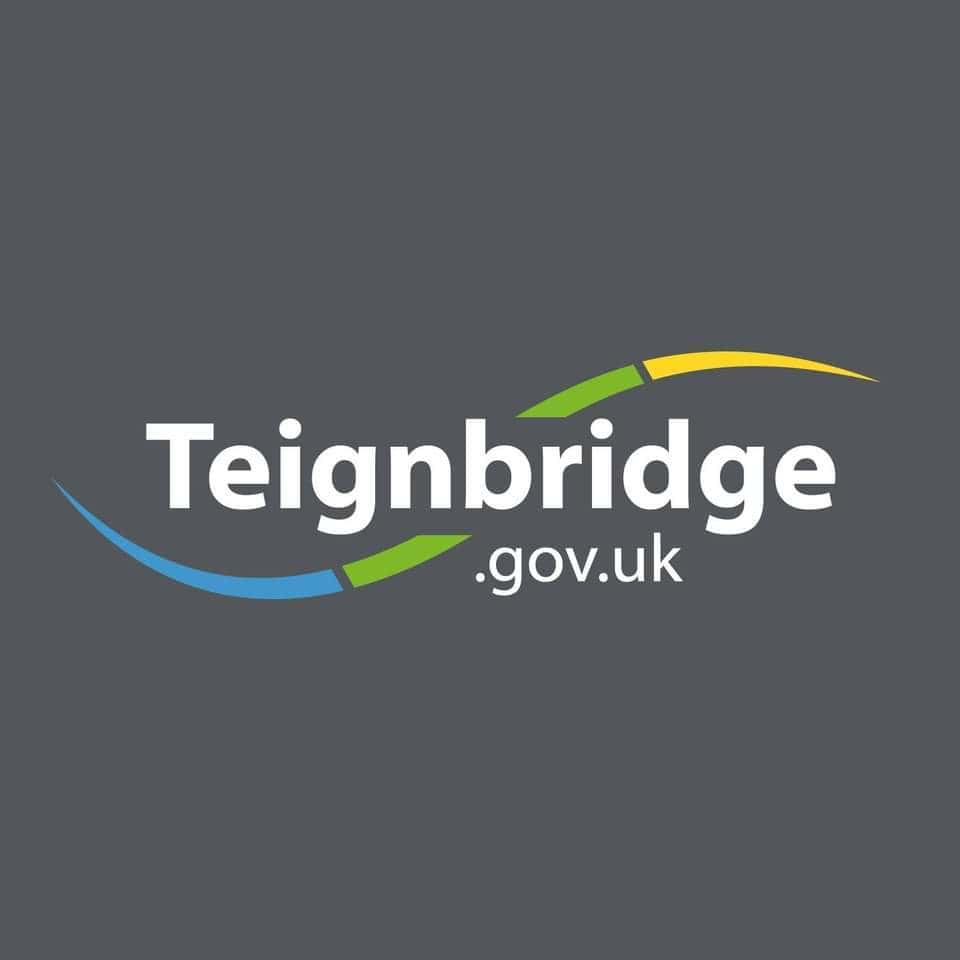 Teignbridge District Council logo with curved blue, green, and yellow lines on a dark grey background and the text "Teignbridge.gov.uk" in white.